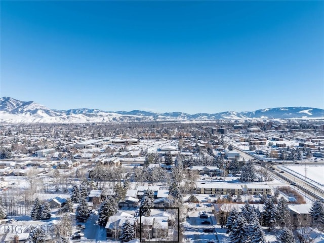 snowy aerial view featuring a mountain view