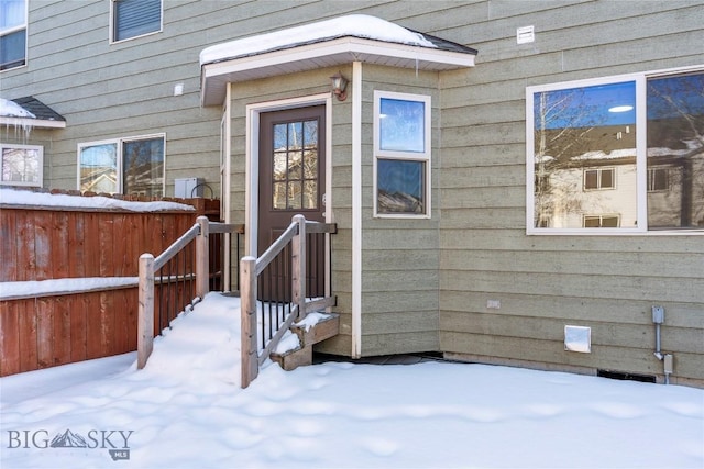 view of snow covered property entrance