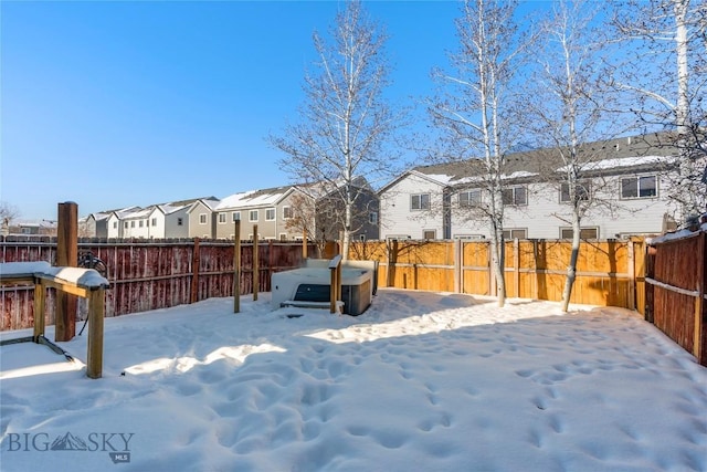 snowy yard featuring a hot tub