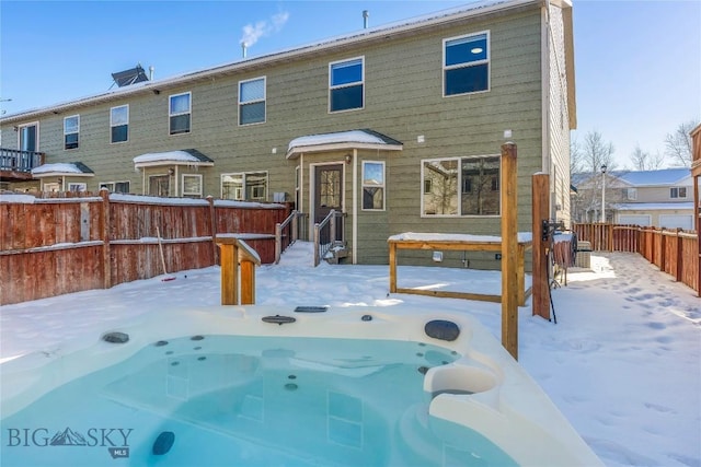 snow covered pool with an outdoor hot tub