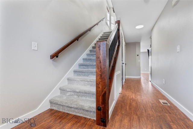 staircase featuring hardwood / wood-style floors