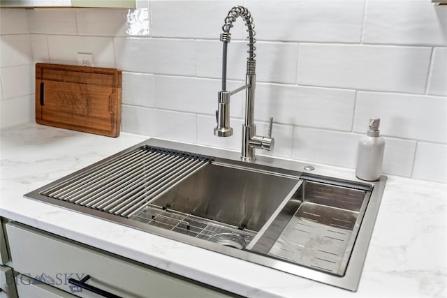 room details featuring sink and backsplash