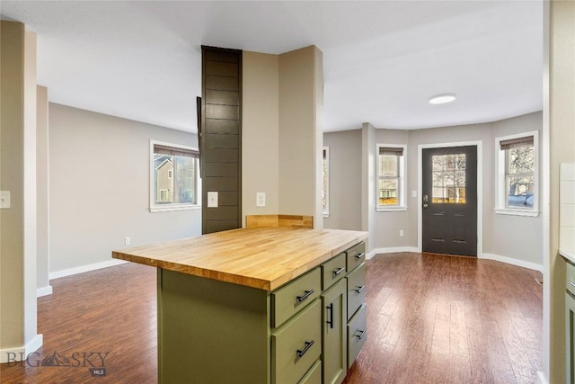 kitchen with dark hardwood / wood-style floors, a kitchen island, wooden counters, and green cabinets