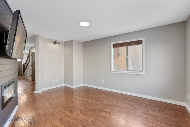 unfurnished living room with dark hardwood / wood-style floors