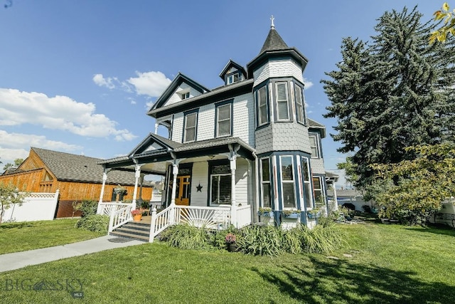 victorian-style house with a front lawn and a porch