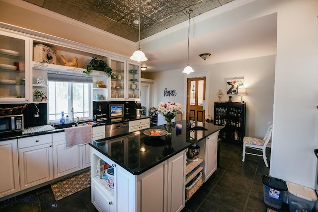 kitchen with pendant lighting, dishwasher, white cabinets, a center island, and crown molding