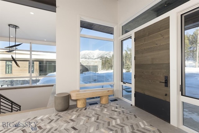 sunroom / solarium featuring a mountain view