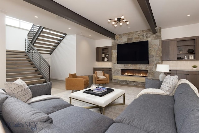 living room featuring beamed ceiling and a fireplace