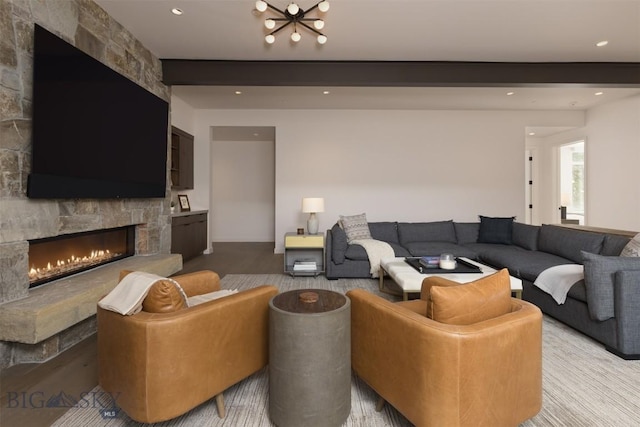 living room featuring beamed ceiling and a fireplace