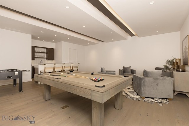 game room with pool table, light hardwood / wood-style flooring, and beamed ceiling