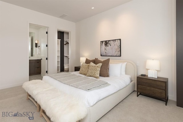 carpeted bedroom with connected bathroom, a spacious closet, and a closet