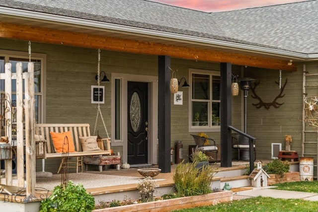 exterior entry at dusk featuring a porch