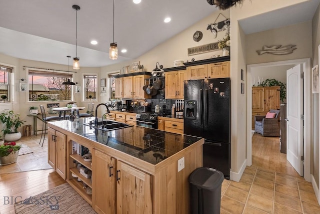 kitchen featuring vaulted ceiling, sink, backsplash, hanging light fixtures, and black appliances