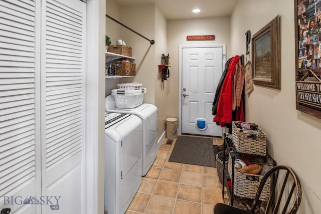 clothes washing area featuring separate washer and dryer and light tile patterned floors