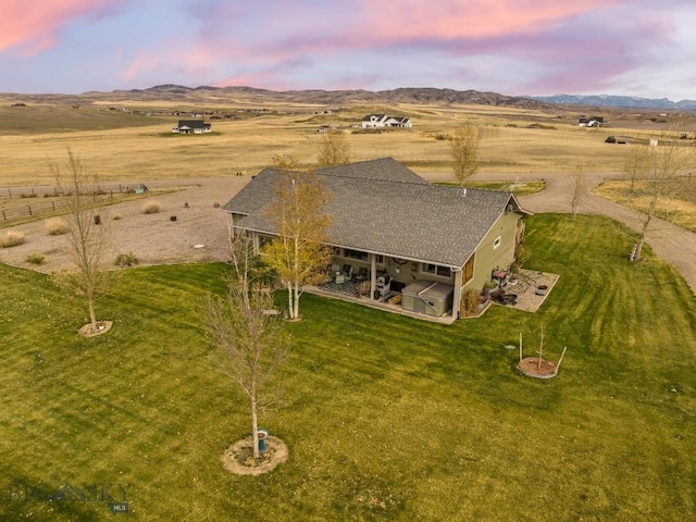 aerial view at dusk featuring a rural view and a mountain view