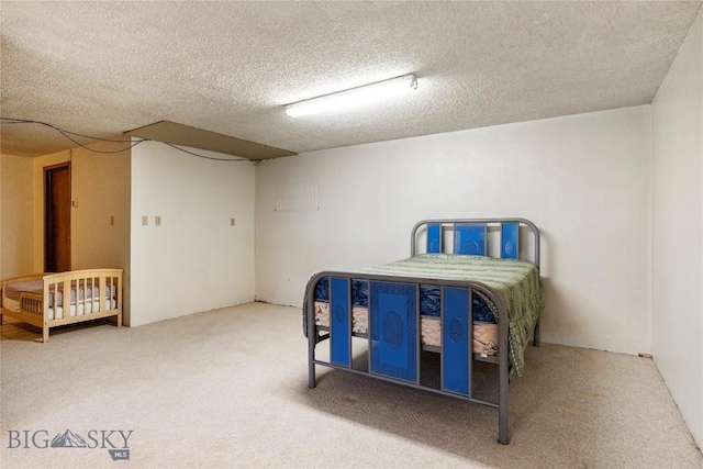 carpeted bedroom featuring a textured ceiling