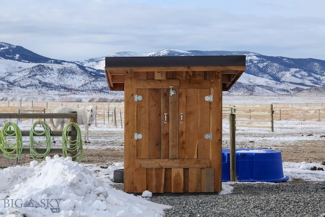 snow covered structure featuring a mountain view