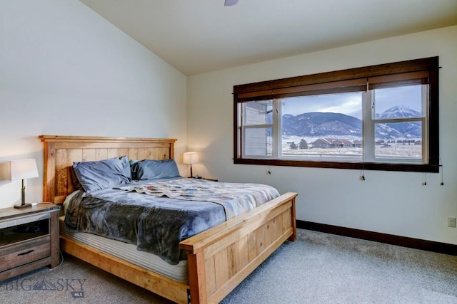 carpeted bedroom with multiple windows, a mountain view, and lofted ceiling