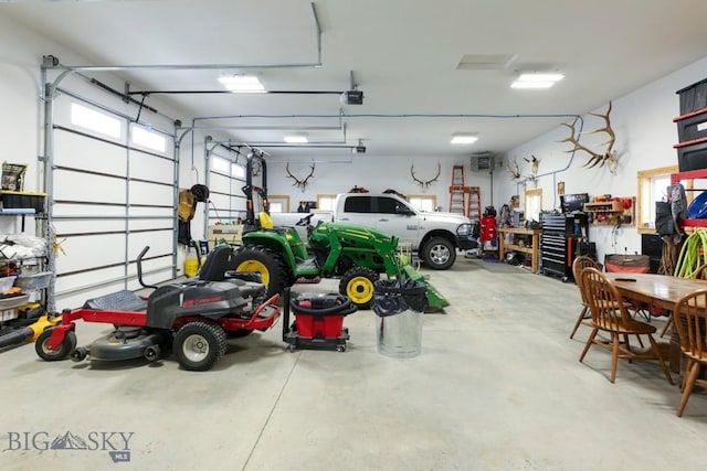 garage with a garage door opener and a workshop area