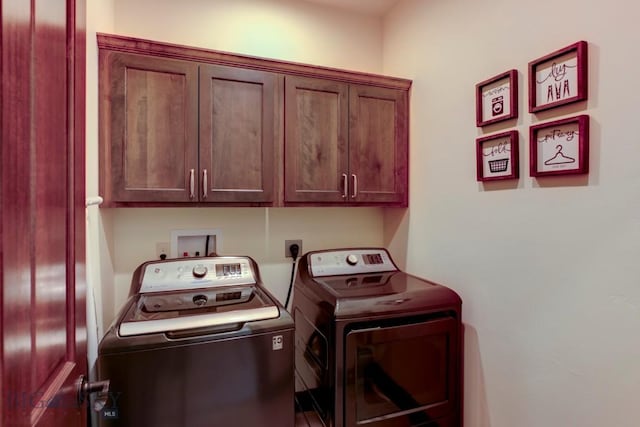 laundry area featuring washing machine and dryer and cabinets