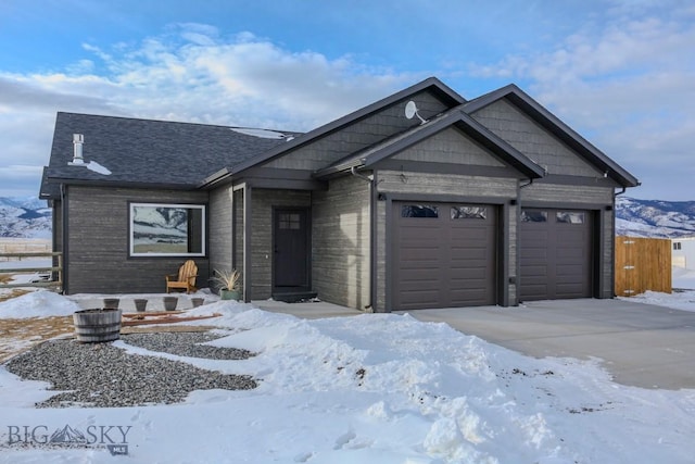 view of front of property featuring a mountain view and a garage