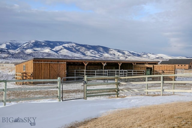 view of horse barn with a mountain view