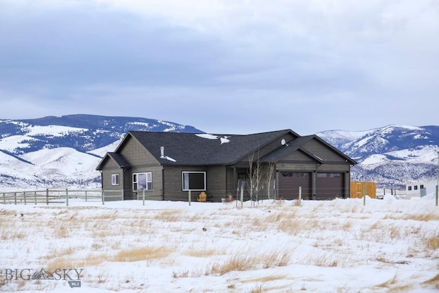 single story home with a mountain view and a garage