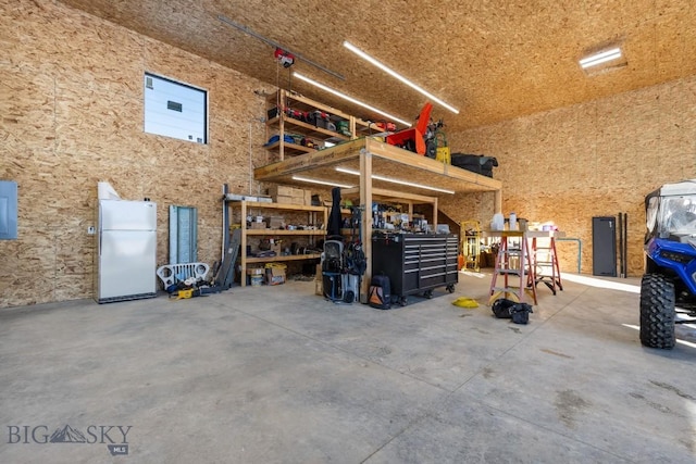 6111 Springhill Rd, Belgrade, MT 59714 - garage with freestanding refrigerator and a workshop area