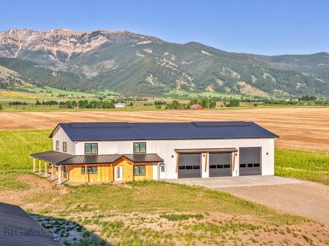 6111 Springhill Rd, Belgrade, MT 59714 - view of front of house featuring dirt driveway, a standing seam roof, metal roof, a mountain view, and a porch