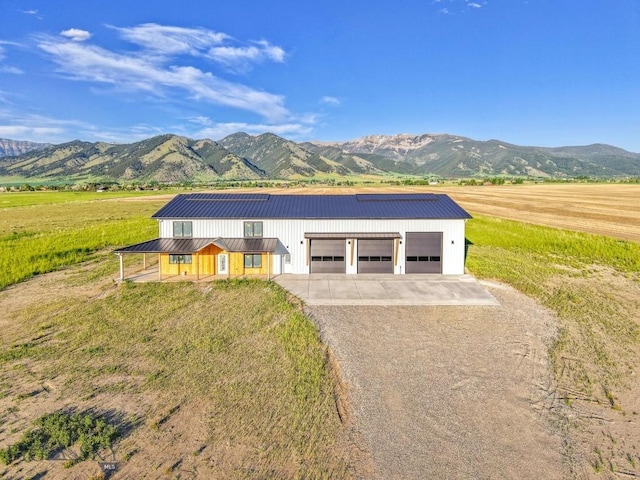 6111 Springhill Rd, Belgrade, MT 59714 - view of front of home with a mountain view, driveway, metal roof, and a rural view
