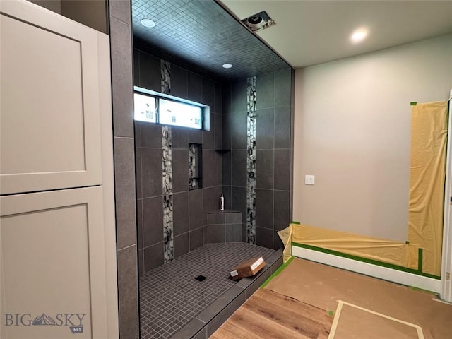 6111 Springhill Rd, Belgrade, MT 59714 - bathroom featuring a tile shower, wood finished floors, and recessed lighting