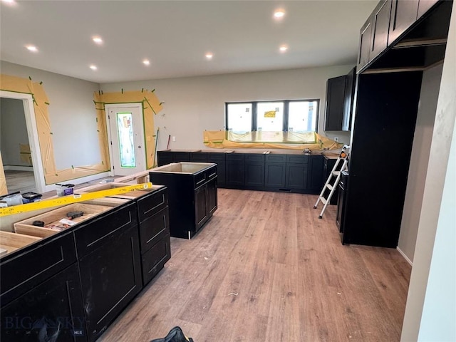 6111 Springhill Rd, Belgrade, MT 59714 - kitchen with dark cabinetry, light wood-type flooring, and recessed lighting