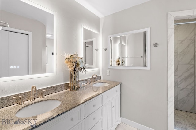 bathroom with vanity and tiled shower