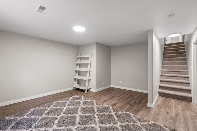 basement with hardwood / wood-style flooring