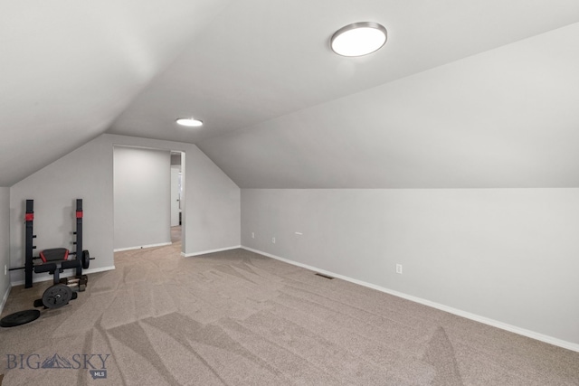 bonus room featuring lofted ceiling and light colored carpet