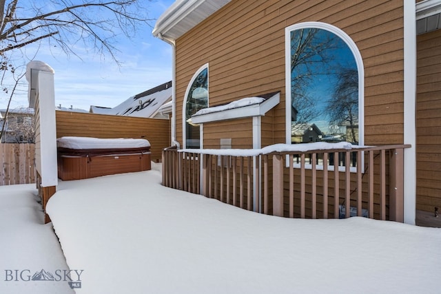 view of snow covered exterior featuring a hot tub