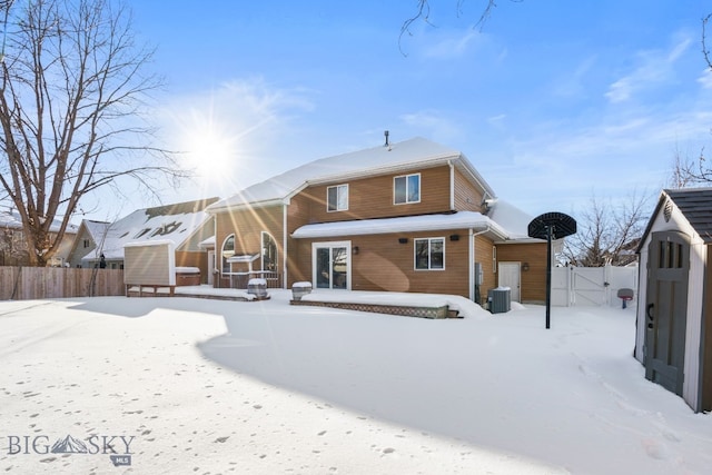 snow covered house with central AC unit