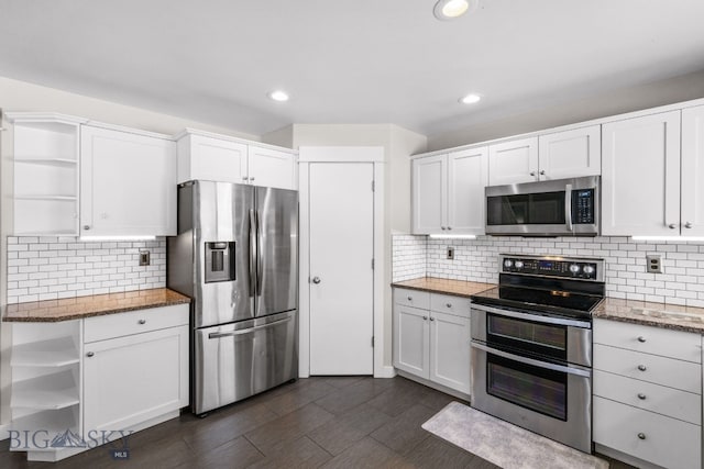 kitchen featuring white cabinetry, stainless steel appliances, and stone countertops