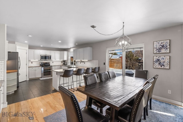 dining space featuring a chandelier and dark hardwood / wood-style flooring