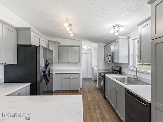 kitchen featuring sink, gray cabinetry, dark hardwood / wood-style floors, black appliances, and a textured ceiling