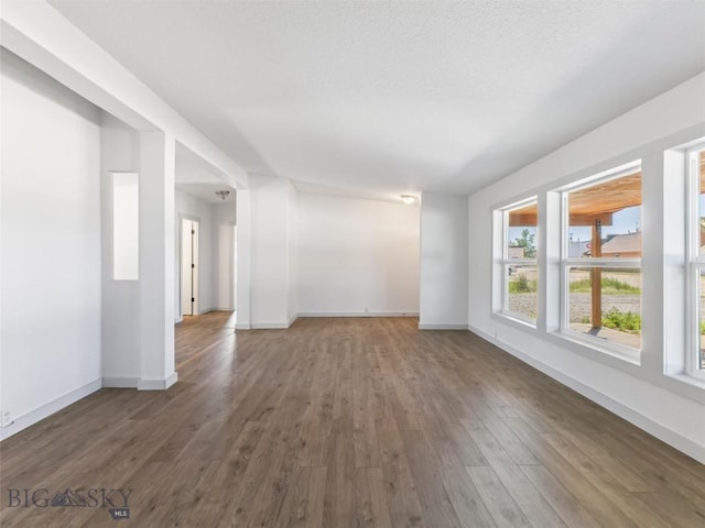 empty room with dark hardwood / wood-style flooring