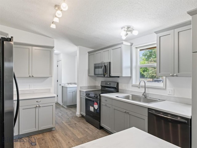 kitchen featuring sink, gray cabinets, and appliances with stainless steel finishes