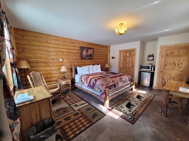 bedroom with fridge and log walls