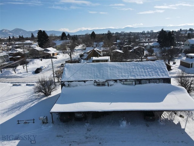 snowy aerial view with a mountain view