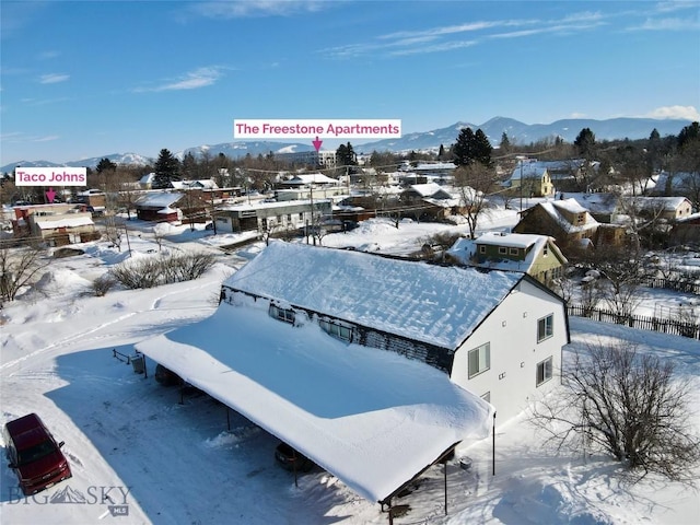 snowy aerial view featuring a mountain view