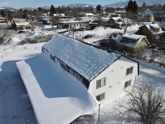 snowy aerial view with a mountain view