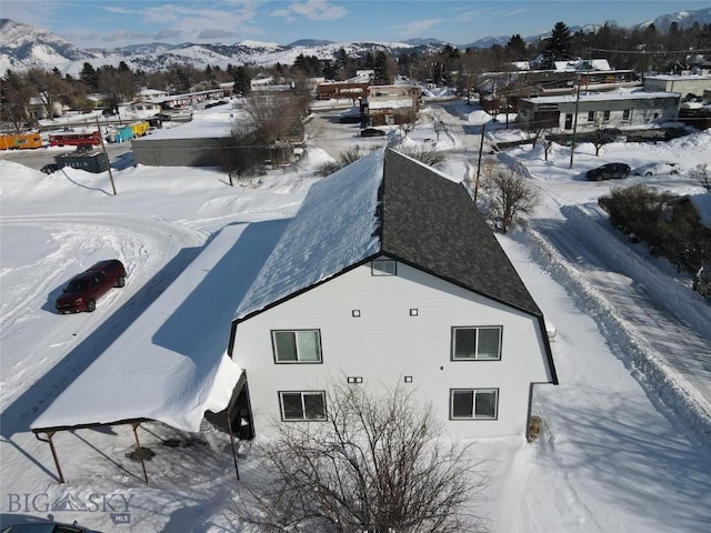 snowy aerial view featuring a mountain view