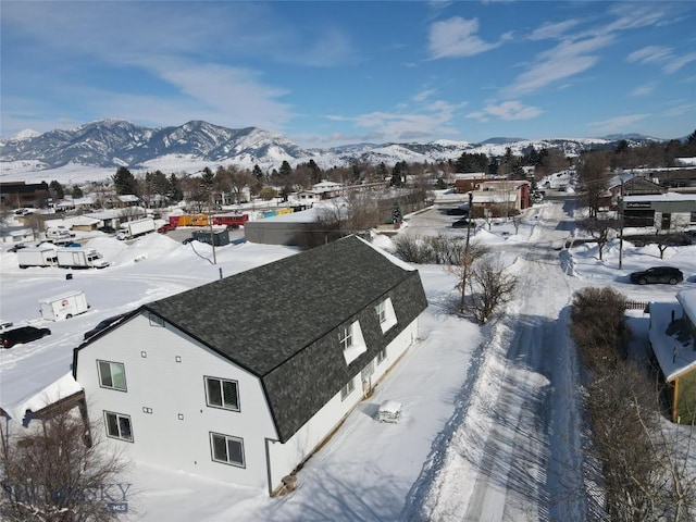 snowy aerial view featuring a mountain view