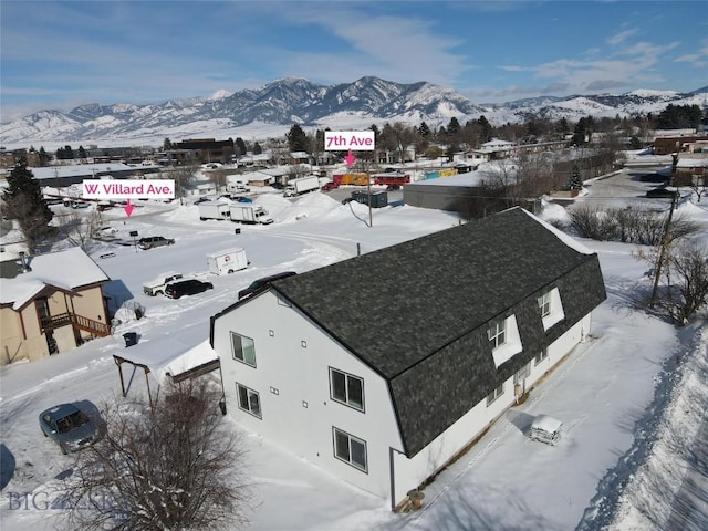 snowy aerial view with a mountain view