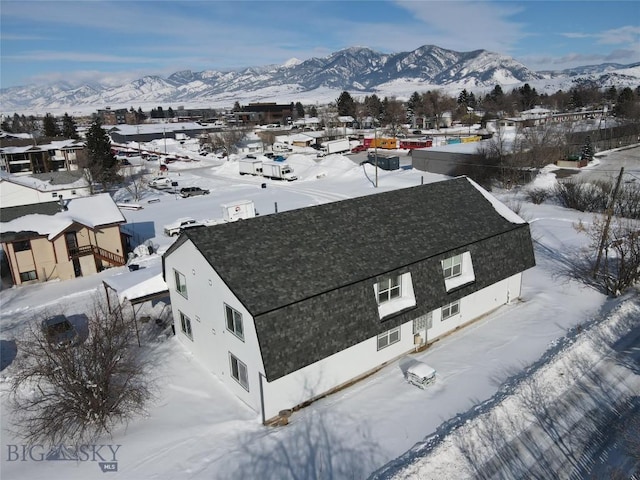 snowy aerial view with a mountain view